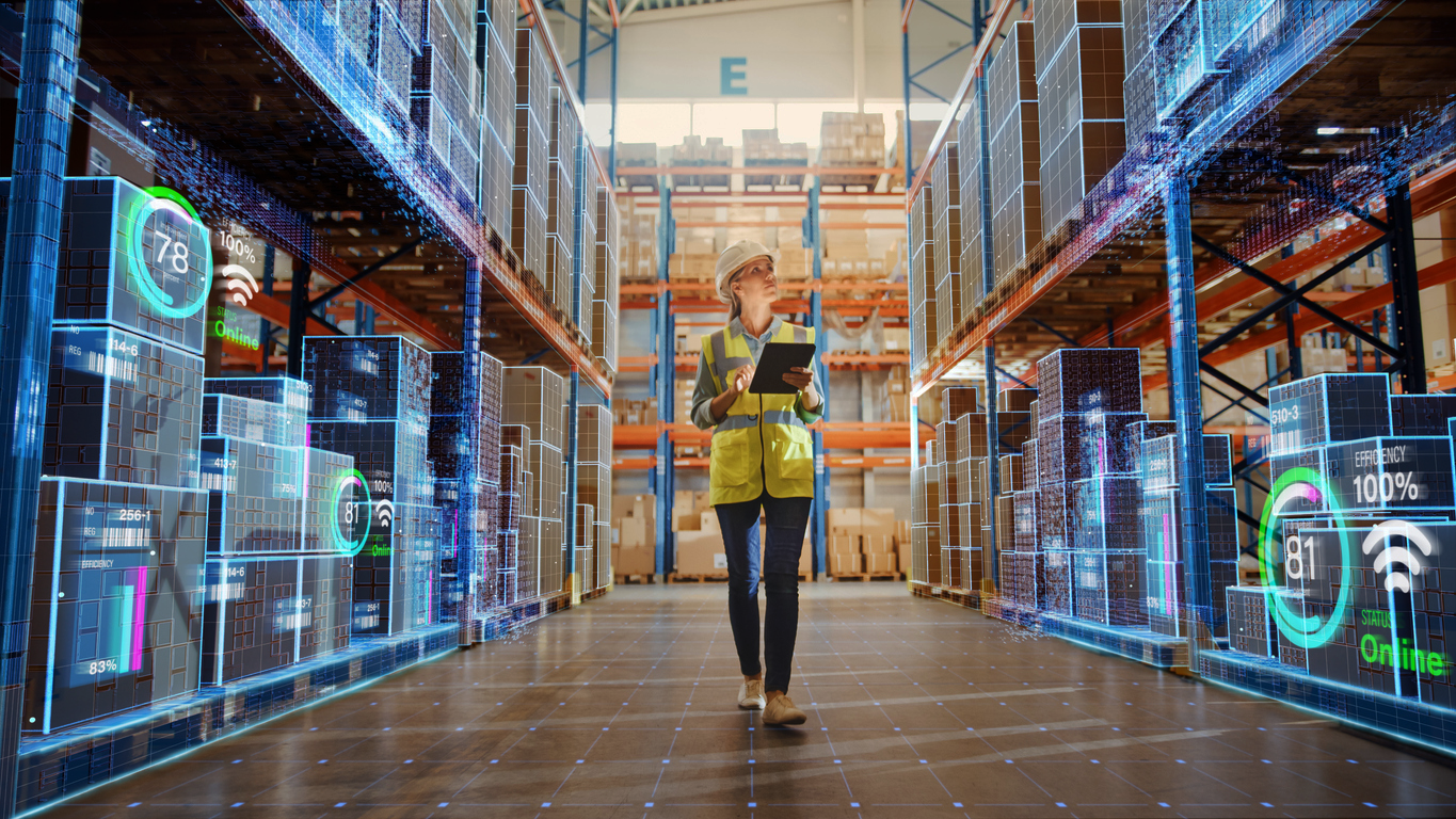 Warehouse worker using a tablet surrounded by digital data overlays showing real-time inventory and efficiency metrics.